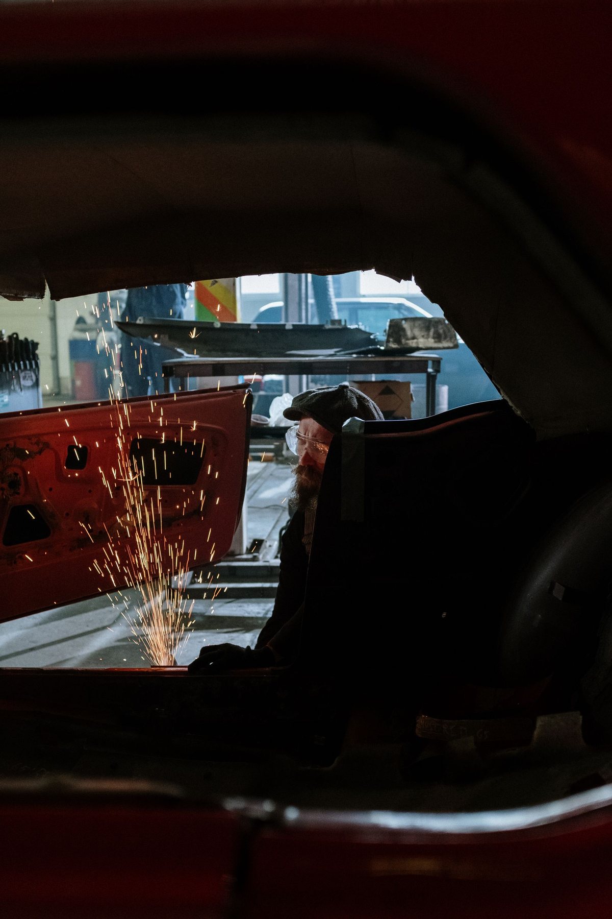 A technician repairing a dent on a car body panel